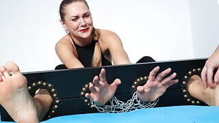 Tormenting her stunning soles locked in stocks