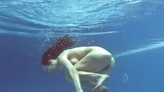 Being nude underwater brings her sexual joys