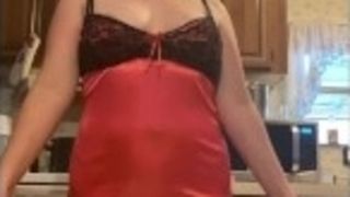 Stepmother dances a striptease in the kitchen in a night sundress