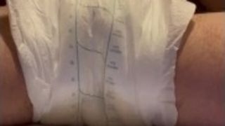 Pissing noisily in an oversized pad